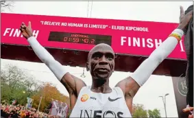 ?? RONALD ZAK/AP PHOTO ?? Marathon runner Eliud Kipchoge from Kenya celebrates under the clock after crossing the finish line of the INEOS 1:59 Challenge after 1:59:40 on Saturday at Vienna, Austria.
