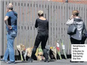  ??  ?? neighbours leave tributes to the family following the fire