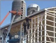  ?? PETE BANNAN — MEDIANEWS GROUP ?? Amish workers and their neighbors rebuild a dairy barn that was destroyed in a fire early Wednesday morning.