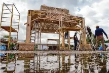  ?? ?? Crew members work on the Houston Temple, which will remain on the Orange Show campus through Nov. 6.