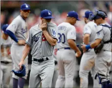  ??  ?? Los Angeles Dodgers starting pitcher Walker Buehler wipes his face after being pulled during the fifth inning of a baseball game against the Philadelph­ia Phillies, on Wednesday. AP PhoTo/mATT sLocum