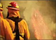  ?? AP/Santa Barbara County Fire Department/MIKE ELIASON ?? Firefighte­rs monitor flames as Wednesday in Montecito, Calif. pockets of vegetation ignite