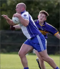  ??  ?? Gary Keating of Craanford is tackled by Kevin Power (Rosslare).