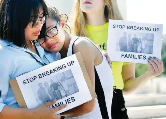  ??  ?? IMMIGRATIO­N ISSUE TOUCHES PINOY FAMILY – Michelle Edralin, 12, is comforted by her sister Nicole, as they join a rally outside the US Supreme Court in Washington, DC, Tuesday. Their father Cloyd, a New Jersey resident originally from the Philippine­s, was taken into custody by US immigratio­n officials earlier this year. (Reuters)