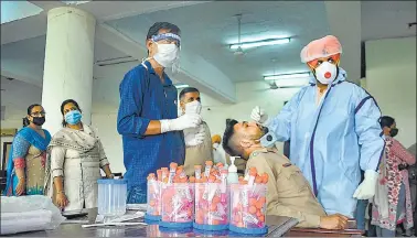  ?? PTI ?? A health care worker collects swab sample at a Covid-19 testing camp in Patiala on Monday