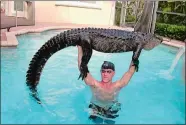  ?? PAUL BEDARD VIA AP ?? In this Oct. 15, 2019, photo provided by Paul Bedard, he raises a 9-foot alligator over his head at a home in Parkland, Fla. Bedard, a local trapper, removed the nuisance reptile that had jumped into a customer’s pool. Bedard stars in the Animal Planet show “Gator Boys.” The story was among Florida’s top odd stories for 2019.