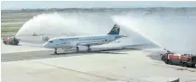  ?? Pictures: ESA ALEXANDER ?? TOUCHDOWN: South African Airlines staff celebrate the arrival of the airline’s first flight, which was given a welcome shower on landing, at Cape Town Internatio­nal Airport on Thursday after a long absence.