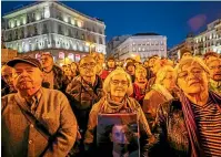  ?? AP ?? People gather to celebrate the exhumation of late Spanish dictator General Francisco Franco in Madrid.