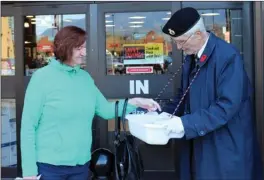  ?? Special to The Okanagan Weekend ?? Bob Ross accepts a donation for a Remembranc­e Day poppy in Kelowna.