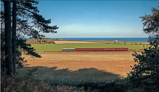  ?? Robert Falconer ?? The North Norfolk Railway’s Class 31 D5631 heads towards Weybourne on October 9, hauling the railway’s rake of Mk.1 suburban coaches in an idyllic scene, with the North Sea in the background.