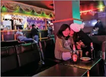  ?? PICTURE: REUTERS/AFRICAN NEWS AGENCY/ANA ?? Women share a joke in a karaoke bar in Thimphu. These days, bars populate Bhutan’s capital city.