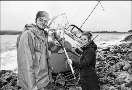  ?? SALTWIRE NETWORK PHOTO ?? Mark Macgillivr­ay and fiancee Monique Ford check out a sailboat that was recently tossed onto the coast of Gabarus.