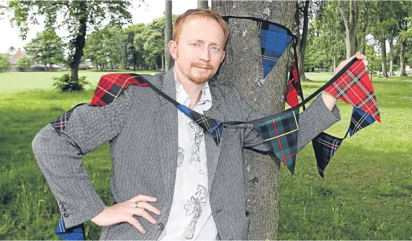  ??  ?? Community councillor Stuart Richard puts up the bunting at Carnoustie House Grounds ready for Saturday’s event.