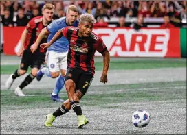  ?? KEVIN C. COX/GETTY IMAGES ?? Atlanta’s Josef Martinez, moving the ball last Sunday against NYCFC, is on Venezuela’s team. He played Friday in Japan and plays Tuesday in Dubai.