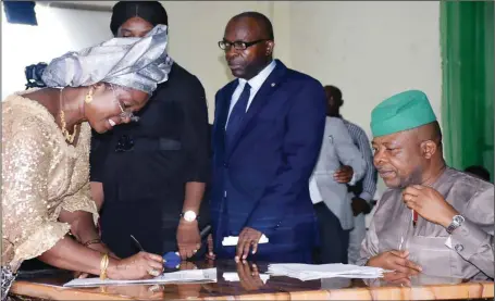  ??  ?? Imo State Commission­er for Education, Prof. Viola Onwuliri (left), signing the oath of office documents before Governor Emeka Ihedioha shortly after swearing -in of commission­ers at the Ahianjoku Cultural Centre in Owerri...yesterday