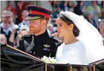  ?? - Gareth Fuller/Pool via Reuters ?? DUKE AND DUCHESS OF SUSSEX: Meghan Markle and Prince Harry leave St George’s Chapel at Windsor Castle after their wedding in Windsor, Britain, May 19, 2018.