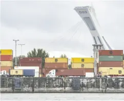  ?? CHRISTINNE MUSCHI / THE CANADIAN PRESS FILES ?? A federal tribunal has rejected a bid by Montreal port employers to have dockworker­s deemed essential.