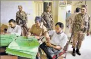  ?? AP ?? Pakistani troops stand guard as Election Commission staff prepare material for the upcoming polls at an office in Lahore.