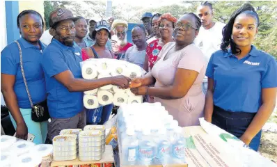  ?? PHOTOS BY CARL GILCHRIST ?? President of the Chesterfie­ld Castleton Citizens’ Associatio­n, Derrick Edwards (second left), hands over supplies to Sharon Burke (second right), matron at the St Mary Infirmary, as treasurer Tamara Barnes (left), secretary Tashekia Edwards (right) and other members of the associatio­n look on.