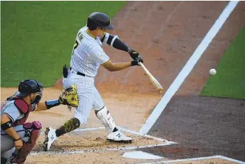  ?? DENIS POROY AP ?? The Padres’ Ha-seong Kim hits an RBI single in the first inning Saturday night against Arizona.