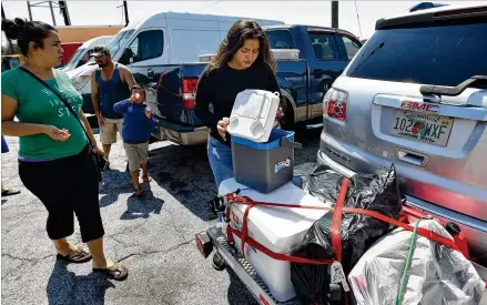  ?? HYOSUB SHIN / HSHIN@AJC.COM ?? Angelica Granados, 14, looks for cold drinks as her family makes a stop at Chevron gas station in College Park. Her family evacuated their trailer home in Naples before the arrival of Hurricane Irma on Friday.