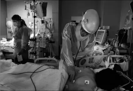  ?? AP Photo/Jae C. Hong ?? In this Nov. 19, 2020, file photo, Dr. Rafik Abdou checks on a COVID-19 patient at Providence Holy Cross Medical Center in the Mission Hills section of Los Angeles.