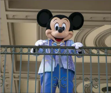  ?? (AP) ?? Mickey Mouse greets visitors at the entrance to Magic Kingdom Park at Walt Disney World Resort in Lake Buena Vista, Fla., in April 2022.
