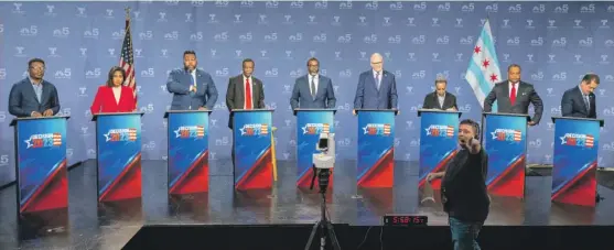  ?? TYLER PASCIAK LARIVIERE/SUN-TIMES ?? From left, Chicago mayoral candidates Ja’Mal Green, Ald. Sophia King (4th), state Rep. Kam Buckner, Willie Wilson, Cook County Board Commission­er Brandon Johnson, Paul Vallas, Mayor Lori Lightfoot, Ald. Roderick Sawyer (6th), and Rep. Jesús “Chuy” García prepare for a forum at NBC5 studios on Feb. 13.