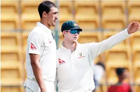  ??  ?? Australia's captain Steve Smith, right, interacts with teammate Mitchell Starc during the fourth day of their second Test match against India in Bangalore on Tuesday. (AP)