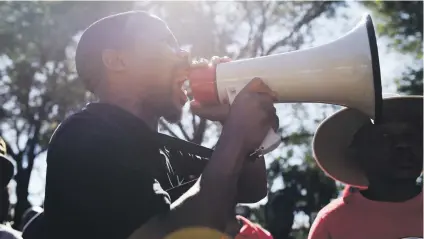  ?? Picture: Refilwe Modise ?? MAKING THEIR VOICE HEARD. A Nehawu member addresses strikers outside the University of Pretoria’s main campus in Hatfield yesterday following failed salary negotiatio­ns with varsity management.