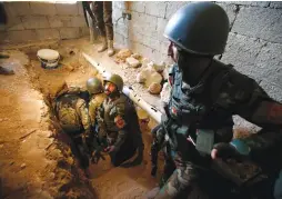  ?? (Azad Lashkari/Reuters) ?? PESHMERGA FORCES inspect a tunnel yesterday that was used by Islamic State in Bashiqa, east of Mosul.