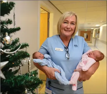  ??  ?? Maternity care assistant Carol Johnston with newborn twins Liam and Freya Fisher