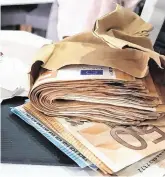  ??  ?? Raid: Some of the cash seized in the Criminal Assets Bureau raid, which amounted to €66,865. Also seized were an Audi car and two phones