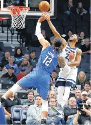  ??  ?? Minnesota Timberwolv­es’ Derrick Rose, right, tries to block a shot by Oklahoma City Thunder’s Steven Adams during Friday’s preseason basketball game.