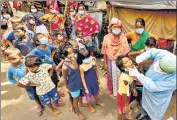  ?? ANI FILE PHOTO ?? A health care worker collects swab samples of underprivi­leged children in Kolkata.