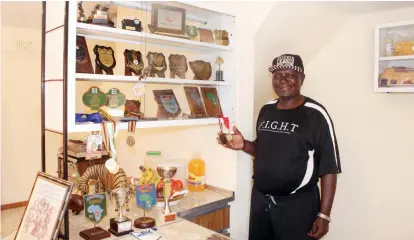  ??  ?? Cosmas ‘‘Tsano’’ Zulu shows the medals he has won in his illustriou­s football career spanning 50 years