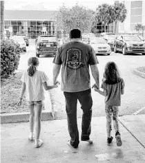  ?? ROUSH RACING VIA AP ?? Ryan Newman and his daughters, Brooklyn Sage, left, and Ashlyn Olivia, leave Halifax Medical Center on Feb. 19. Newman was released about 42 hours after his frightenin­g crash on the final lap of the Daytona 500.