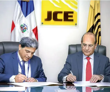  ??  ?? Jaime Guevara, director general de la empresa española Alhambra Systems, S. A., y Julio César Castaños Guzmán, presidente de la JCE, firman el contrato por US$566,037.73 correspond­ientes a honorarios y gastos de servicios de la auditoría forense a los equipos del voto automatiza­do que se utilizaron en las elecciones primarias del domingo 6 de octubre pasado.