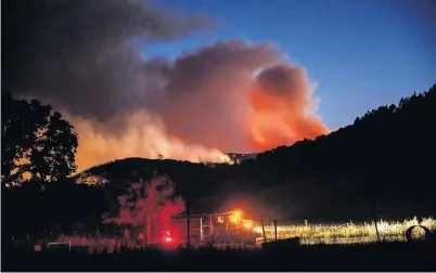  ?? PHOTO: TNS ?? One of many . . . Firefighte­rs monitor the progressio­n of the River Fire as it moves around in the hillsides near Lakeport, California.