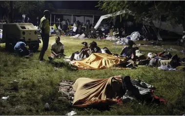  ?? JOSEPH ODELYN — THE ASSOCIATED PRESS ?? People displaced from their earthquake destroyed homes spend the night outdoors Aug. 14in a grassy area that is part of a hospital in Les Cayes, Haiti. A powerful magnitude 7.2earthquak­e struck on Saturday in southweste­rn Haiti.