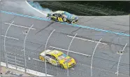  ?? MIKE MCCARN/AP PHOTO ?? Ryan Blaney (12) drives past the wrecked car of Jimmie Johnson (48) to win the NASCAR Cup race on Sunday at Charlotte Motor Speedway in Concord, N.C.