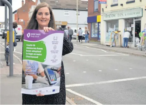  ??  ?? Councillor Shona Rattray, lead for business support at Charnwood Borough Council, with a poster for the Shop Safe, Shop Local campaign