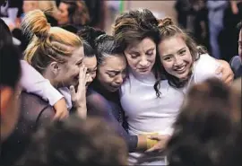  ?? Wally Skalij Los Angeles Times ?? COACH VALORIE KONDOS FIELD, second from right, hugs some tearful Bruins gymnasts after their third-place finish at the NCAA championsh­ip meet.
