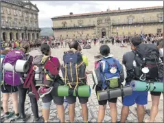  ?? Photos by Cecily Bailey ?? At, left, a youth group gathers and celebrates upon arriving at the plaza in front of the Cathedral of Santiago de Compostela. Below, a Roman bridge in the province of Ponteverda. The bridge is open to both walkers and cars.