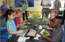  ?? DIGITAL FIRST MEDIA FILE PHOTO ?? A kindergart­en class at Rupert Elementary School in Pottstown eat a salad of healthy greens they made using an indoor tower garden. As children age, their nutritiona­l needs change.