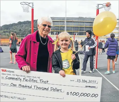  ??  ?? It was a case of the oldest and the youngest netballers on Saturday, as 89-year-old Lorraine Duffy and five year-old Addyson Guy handed over $100,000. The money from Netball Hutt Valley is their contributi­on towards the Walter Nash Stadium upgrade.
