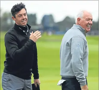  ??  ?? Rory McIlroy, playing with dad Gerry, progressed to today’s final round on the cut-line.