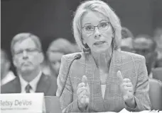  ?? WIN MCNAMEE, GETTY IMAGES ?? Education Secretary Betsy DeVos halted Obama-era rules aimed at protecting students from predatory colleges.