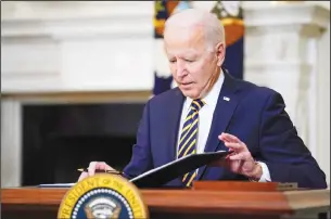  ??  ?? In this file photo, President Joe Biden closes the folder after signing an executive order relating to US supply chains, in the State Dining Room of the White House in Washington. (AP)