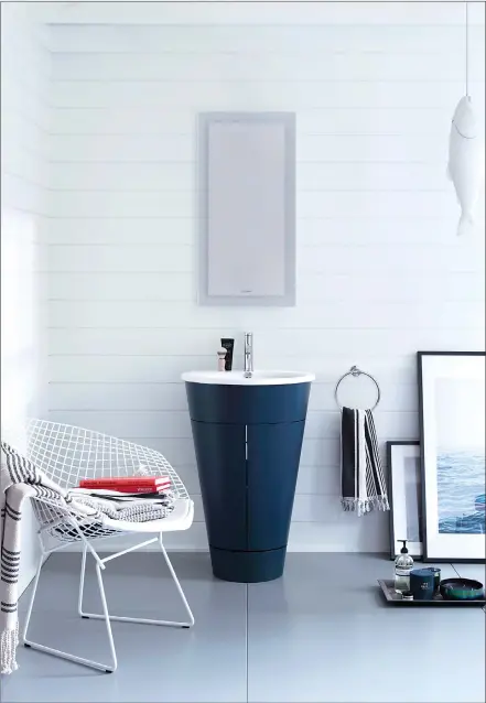  ?? Associated Press photos ?? This photo shows Duravit's Starck 1 barrel vanity and is now available in an inky blue. The color and unique shape make it a standout piece in bathrooms of any size.